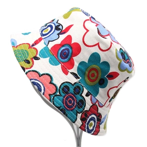 Detailed close-up of children's sun hat with colorful floral patterns and canvas texture