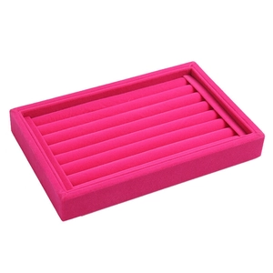 Detailed close-up of rose red velvet jewelry tray with seven slots for rings and studs