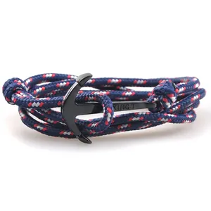 Macro detail of nautical multi-layer braided rope bracelet with black metal anchor hook