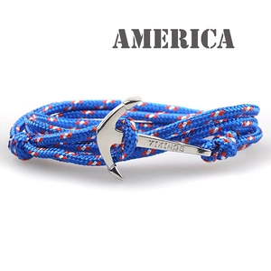 Detail of nautical braided nylon bracelet featuring a silver Viking anchor clasp