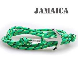 Close-up of green and yellow nylon braided bracelet with a silver anchor clasp