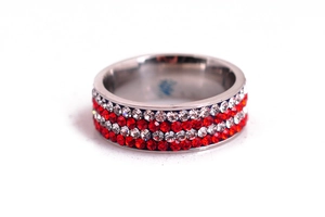 Detailed view of silver stainless steel ring with red and white crystal inlay rows