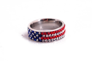 Macro shot of stainless steel ring with red white and blue rhinestones US flag pattern