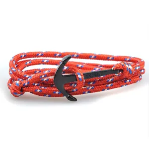 Detail of red nautical braided rope bracelet with black metal anchor clasp hardware