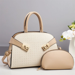 Close-up of beige woven texture handbag with golden hardware and matching pouch