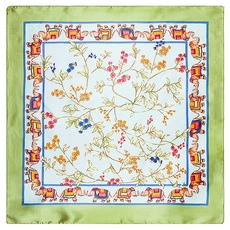 Detailed pattern of floral and elephant motifs on a green silk-like square scarf