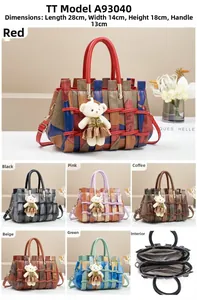 Detailed view of color-block woven handbag with bear charm and multi-compartment design