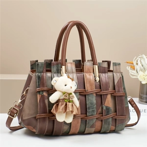 Detail of multi-functional crossbody bag with teddy bear charm and woven straps