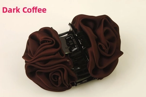 Close-up of a large dark brown fabric rose flower banana hair clip for women