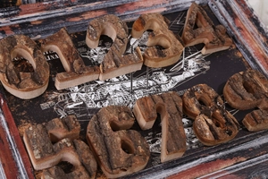 Close-up of thick wooden numbers with natural bark texture for vintage DIY decor