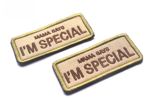 Macro view of two khaki embroidered patches with MAMA SAYS I'M SPECIAL text in brown