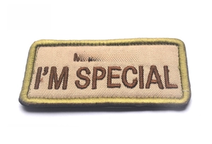 Close-up of MAMA SAYS I'M SPECIAL embroidered patch with khaki twill and olive border