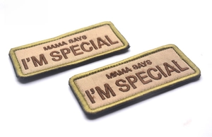 Detail of embroidered patch showing Mama Says I'm Special text and olive green stitching