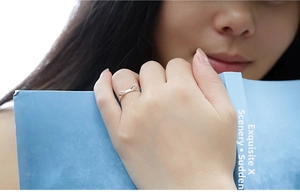 Close-up of minimalist cat ear ring in silver finish worn while reading a book