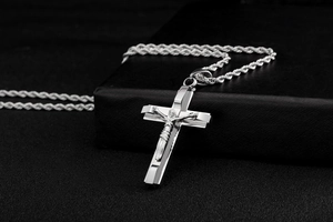 Close-up of silver titanium steel cross pendant with twisted rope chain for men