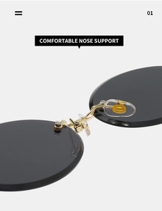 Detail of adjustable silicone nose pads and gold metal bridge on rimless sunglasses