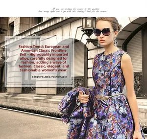 Close-up of golden leaf buckle elastic waist belt styled on a purple floral dress