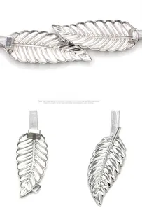 Detailed view of silver leaf buckle and elastic metal spring chain belt for women