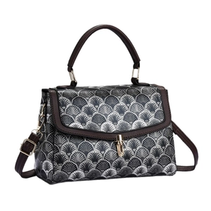 Chic geometric pattern crossbody bag with brown faux leather trim and gold metal clasp