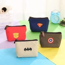 Close-up of four canvas coin purses with superhero logos and durable metal zippers