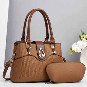 Detailed view of brown woven texture handbag set with gold teardrop lock and pouch