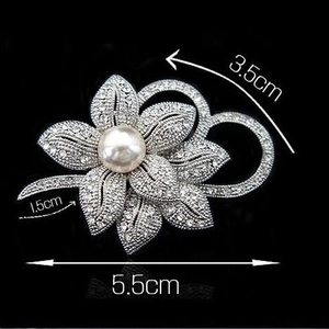 Silver flower brooch with pearl and rhinestones detail showing 5.5cm by 3.5cm dimensions
