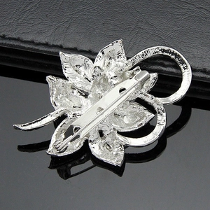 Elegant floral pearl brooch featuring silver metal petals and secure pin clasp closure