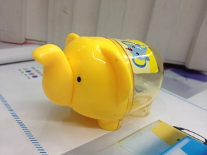 Detail of yellow elephant pencil sharpener with transparent waste container for kids
