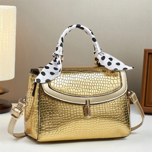 Golden crocodile pattern handbag with silk scarf handle and metallic clasp closure