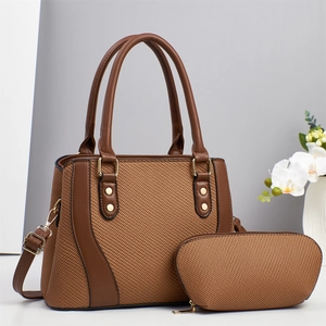 Brown woven tote and clutch set with gold hardware and adjustable crossbody strap