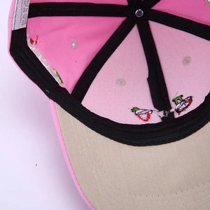 Detail view of cotton baseball cap interior featuring a 100% cotton wash label