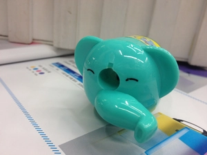 Close-up of a teal elephant-shaped pencil sharpener with a smooth plastic finish
