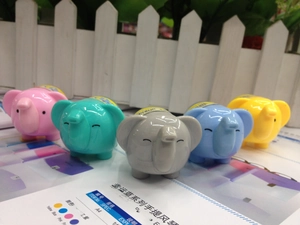 Detailed view of elephant shaped portable fans in five assorted pastel colors set on paper