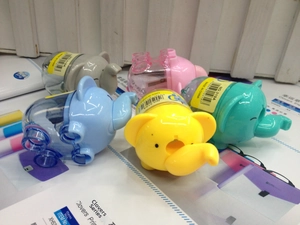 Close-up of elephant-shaped pencil sharpeners with transparent shavings collector cases
