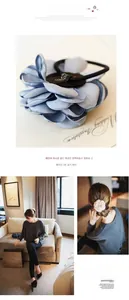 Detailed view of layered fabric flower hair ties in dusty blue and soft pink colors