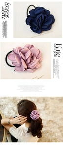 Detailed view of layered satin rose hair ties in navy and pink on a ponytail