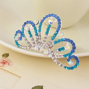 Macro shot of blue and clear rhinestones on a metal crown hair comb with floral patterns