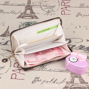 Detail view of long embroidered wallet interior with multiple card slots and coin pocket