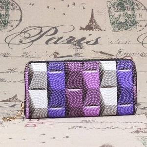 Detail view of purple woven texture long wallet with gold zipper on vintage background