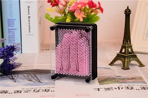 Close-up of 3D pin art toy with pink high-density needles and a black frame