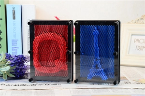 Detail of red and blue 3D pin art toys featuring letter G and Eiffel Tower shapes