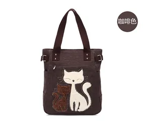Detail of coffee canvas tote bag with cat embroidery and sparkling beadwork accents