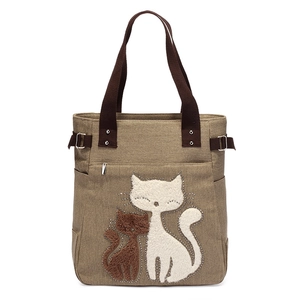 Khaki canvas tote bag with embroidered white and brown cat patterns and brown handles