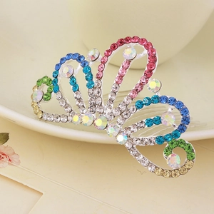 Macro detail of alloy hair comb crown with colorful rhinestones on decorative background