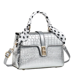 Silver crocodile embossed crossbody bag with polka dot scarf handle and gold twist lock
