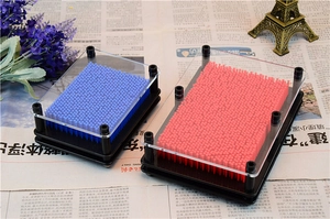 Close-up of blue and pink 3D Pin Art toy showing plastic frame and dense pin pattern