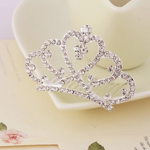 Macro detail of silver crown hair comb with sparkling rhinestones and heart patterns