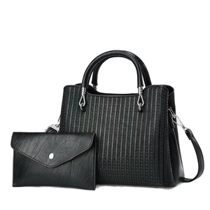 Women's black faux leather handbag set with geometric pattern and small pouch