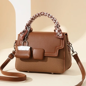 Fashionable square crossbody bag in brown leather and tweed with silk scarf handle