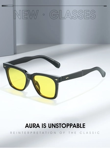 Detail of square sunglasses with yellow lenses and golden arrow rivet decorations
